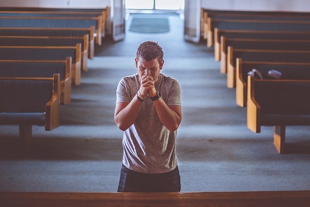 man praying on his knees