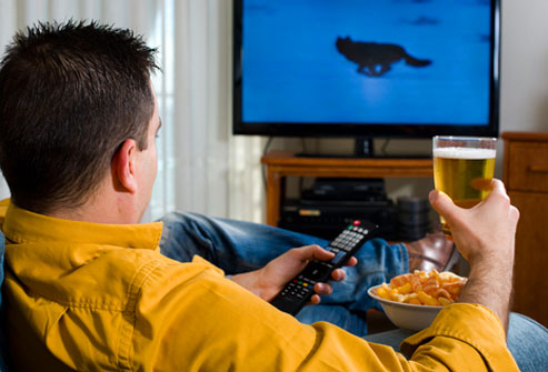 man with beer watching tv
