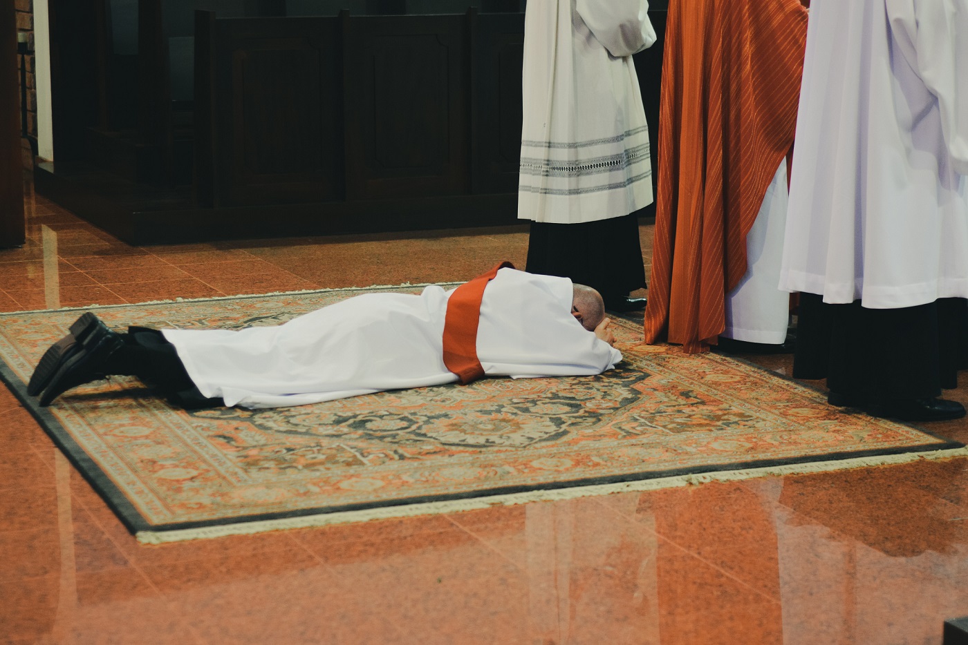 priest laying on the floor